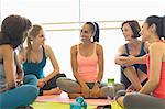 Smiling women talking in exercise class gym studio