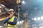 Steel worker with walkie-talkie in factory