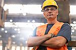 Portrait serious confident steel worker in factory