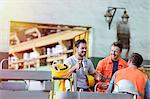 Smiling steel workers enjoying coffee break ins factory