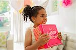 Eager girl holding birthday gift