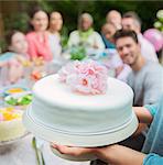 Close up white fondant cake with pink flowers