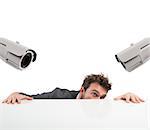 Cameras pointed at a businessman who hides