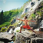 Yoga in a natural landscape with waterfall