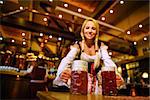 Young girl with beer mugs