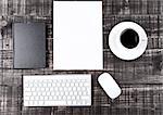 Keyboard with phone paper sheet and coffee cup on office desk