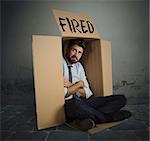 Desperate and fired businessman hides in the cardboard