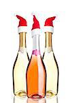 Bottles of pink yellow champagne with santa hat on white background