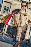 Rediscovering things everybody love in Milan. Full length portrait of happy modern tourist woman with shopping bags at Piazza del Duomo in Milan, Italy standing