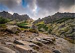 Rocky Hiking Trail with Sun Shining From Behind the Peaks in Mountains Under Dramatic Sky. Mlynicka Valley, High Tatra, Slovakia.