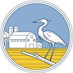 Illustration of a great blue heron perched on a branch viewed from the side set inside circle with barn farm silo in the background done in retro style.