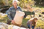 Portrait couple gardening holding potting soil in autumn garden