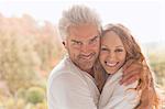 Portrait smiling affectionate couple hugging outdoors