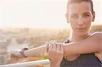 Close up portrait determined female runner stretching arms