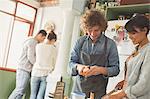 Young couple roommates cooking in kitchen