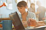 Young man and woman college students studying using laptop