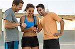 Athletes laughing at message on mobile phone, Van Nuys, California, USA