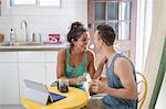 Young couple sharing coffee at kitchen table