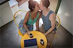 High angle view of romantic young couple kissing at kitchen table