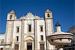 Renaissance Fountain in the foreground with St. Anton's Church behind, Evora, UNESCO World Heritage Site, Portugal, Europe