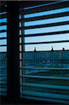 View of the Louvre courtyard through window blinds in winter, Paris, France