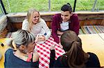 Four adult friends talking in cafée