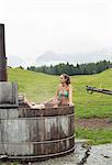 Two female friends relaxing in rural hot tub, Sattelbergalm, Tyrol, Austria