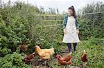 Woman wearing apron on chicken farm
