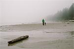 Father and son walking on beach, rear view, Long Beach, Vancouver Island, British Columbia, Canada