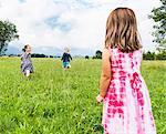 Children running in field, Fuessen, Bavaria, Germany