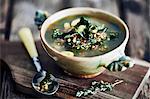 Bowl of broth on wooden cutting board