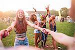 Group of friends at festival, covered in colourful powder paint