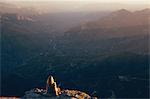 Woman sitting on edge of Moro Rock, Sequoia National Park, California, USA