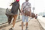 Skateboarder couple walking on street, Budapest, Hungary