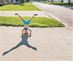 Boy doing handstand on driveway