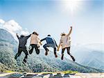 Group of people jumping in air, rear view, Sequoia National Park, California, USA