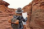 Woman looking at map, rear view, Page, Arizona, USA