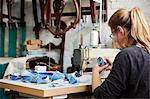 An upholstery workshop. Two women seated using sewing machines.