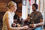 Couple interacting while having sushi