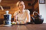 Woman eating sushi in restaurant