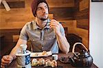 Man eating sushi in restaurant