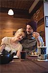 Couple interacting while eating sushi