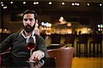 Man looking at glass of red wine