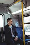 Businessman talking on the mobile phone while travelling
