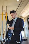 Businessman listening to music and using on mobile phone