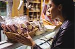 Woman selecting sausage at meat counter