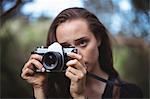 Beautiful woman standing with camera