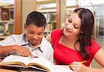 Hispanic Mother and Son Studying Inside The Library.