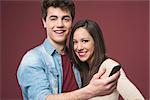 Young teen couple having fun together with a smart phone