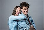 Happy young couple posing together and smiling at camera